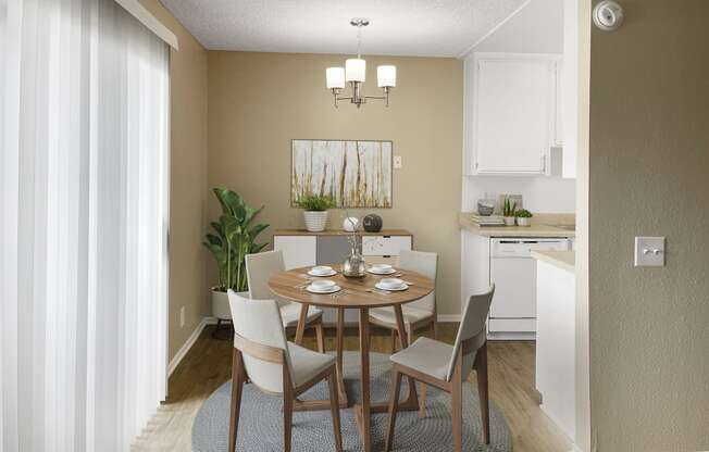 a dining room with a table and chairs and a kitchen in the background