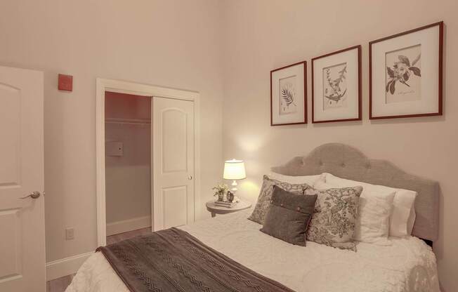 a bedroom with a bed and some pictures on the wall