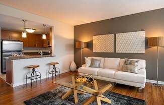 Living room with vinyl plank flooring and view of kitchen
