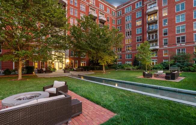 a courtyard with a fire pit and a large building