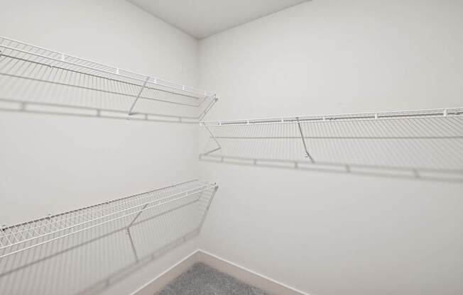 Empty white shelves in a room.