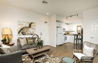 Open concept kitchen with the white refrigerator atove microwave cabinets