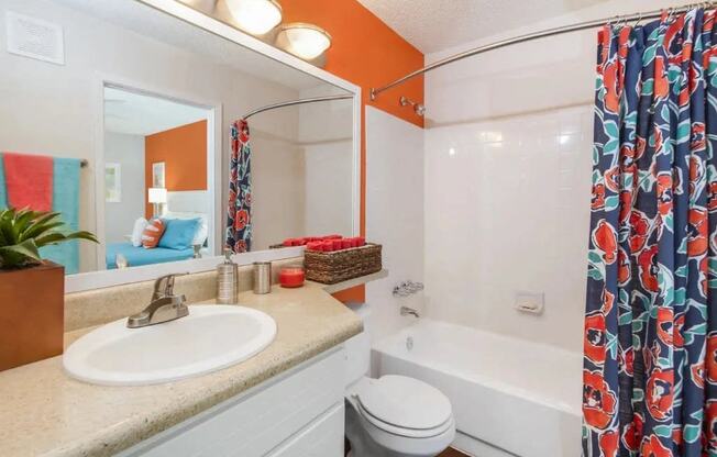 a bathroom with a shower and a sink and a toilet