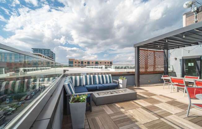 A rooftop patio with a blue couch and wooden deck at Regatta Sloans Lake Apartments, Colorado, 80204