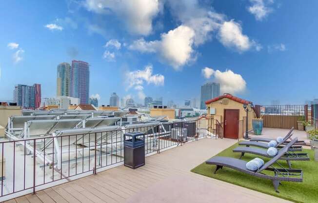 A rooftop patio with a view of the city skyline.