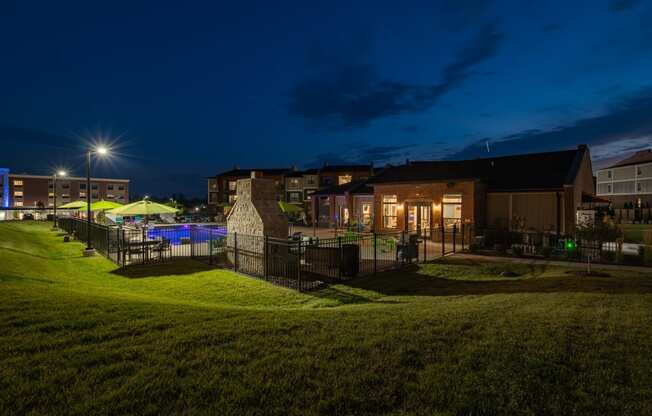 Clubhouse Overlooking The Fenced-In Pool & Sundeck At Night
