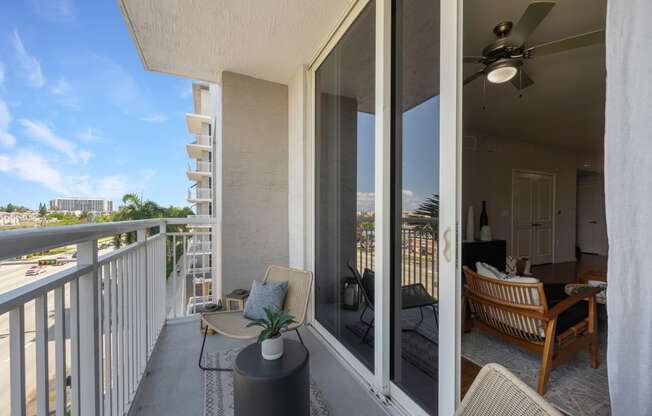 the view from the balcony of a condo with a patio and chairs