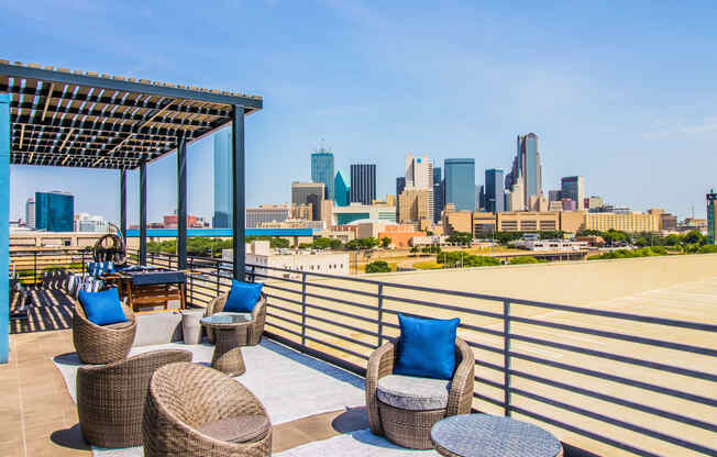 a rooftop deck with chairs and a view of the city at South Side Flats, Texas, 75215