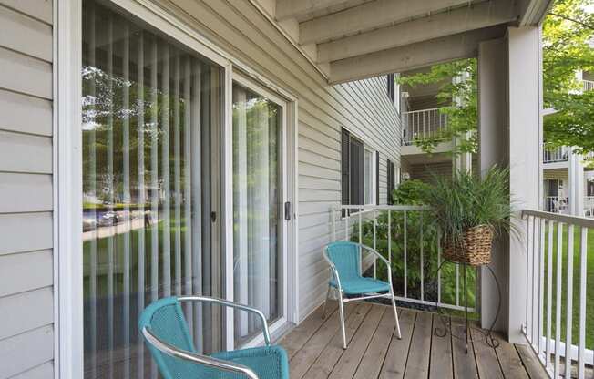 Personal outdoor patio with two blue chairs