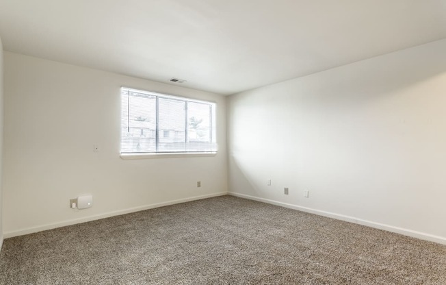 a bedroom with white walls and carpet and a window at Pheasant Run in Lafayette, IN 47909