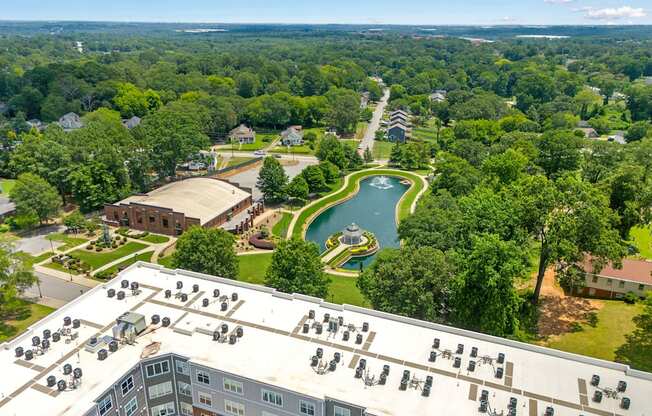 A bird's eye view of a resort with a pool and a building with a lot of windows.