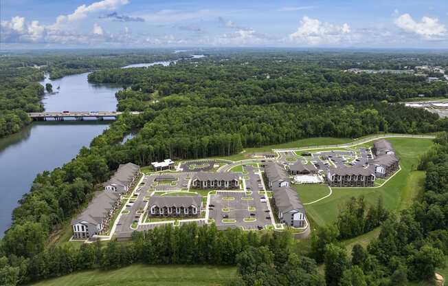 an aerial view of a campus with a body of water