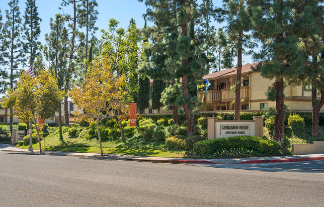 a building with a street in front of it and trees