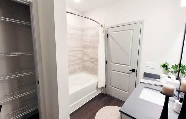 a bathroom with a shower and a sink