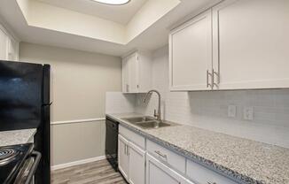 a kitchen with stainless steel appliances and wooden cabinets