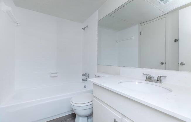 a room with a sink and a mirror