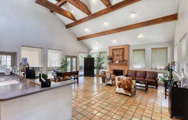 a large living room with a fireplace and a large tile floor