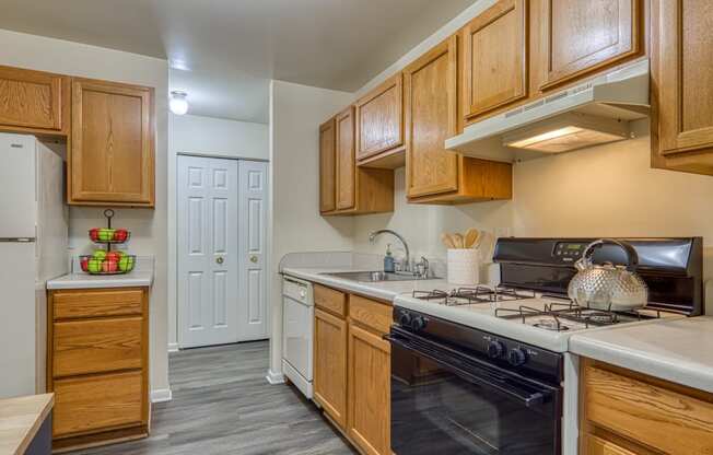 a kitchen with a stove top oven and a refrigerator