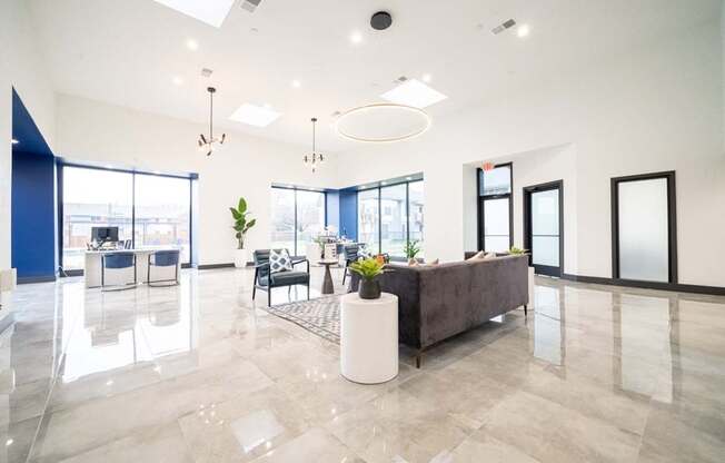 a large living room with a couch and a table with chairs