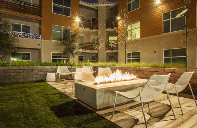 Apartments in San Mateo for Rent - Mode Apartments - Fire Pit and Seating Surrounded by Mode Building