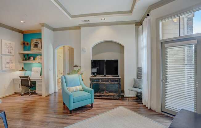 a living room with a fireplace and a blue chair