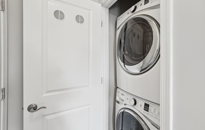 A white door with a washing machine behind it.