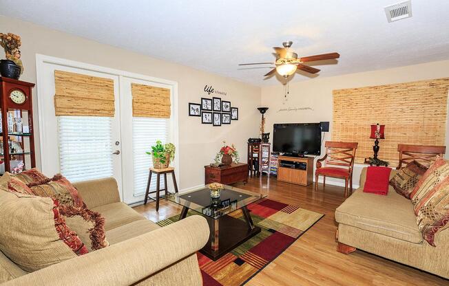 a living room filled with furniture and a flat screen tv