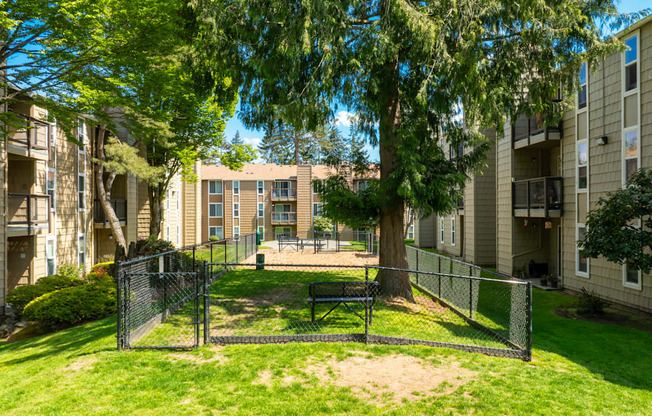 A sunny day at a residential complex with a playground in the foreground.