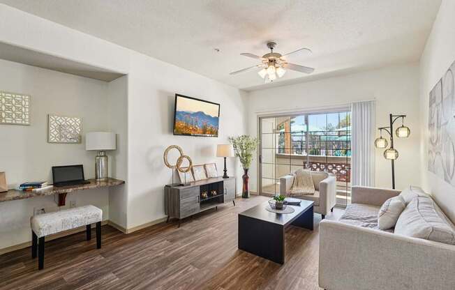 A living room with a couch, chair, and a painting on the wall.