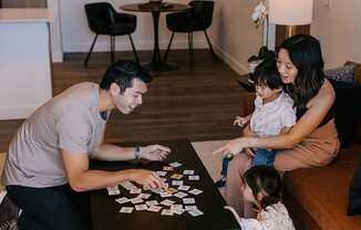 A family playing a board game together in their living room.