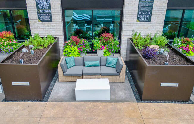 a seating area with couches and a coffee table in front of a building