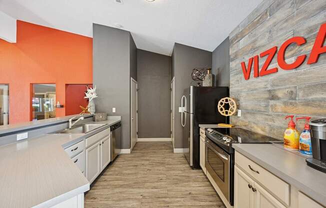 A kitchen with a refrigerator and a microwave.