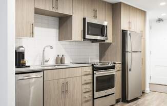 a kitchen with wooden cabinets and stainless steel appliances