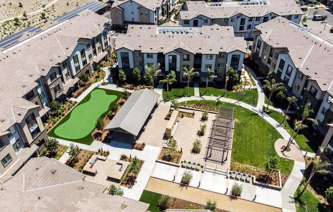 an aerial view of a subdivision with large houses and a green lawn