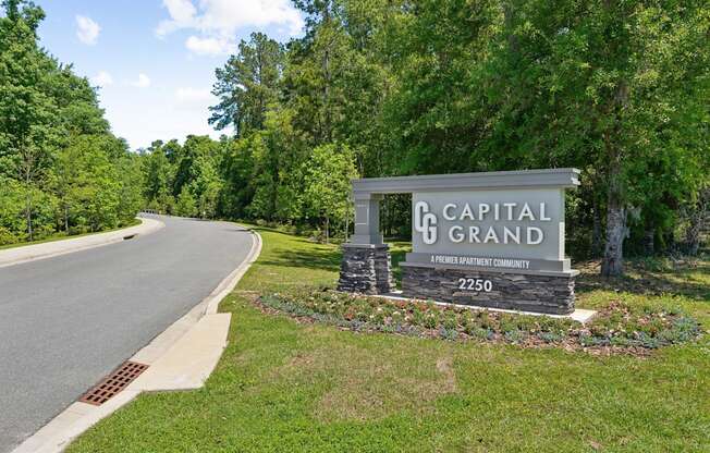 Capital Grand sign on the side of a road at Capital Grand Apartments in Tallahassee, FL