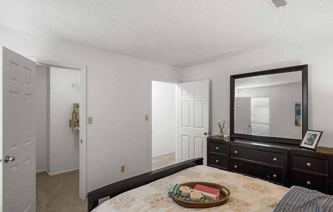 a bedroom with a bed and a mirror