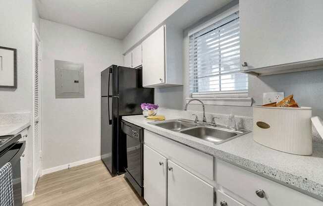 a kitchen with a sink and a refrigerator
