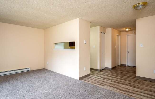 Empty room with wooden floors and white walls.