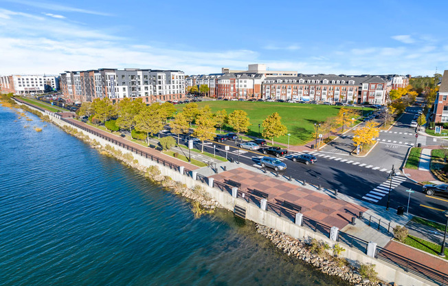 A view of a waterfront with a road and apartment buildings at Harbor Pointe Apartments, New Jersey, 07002