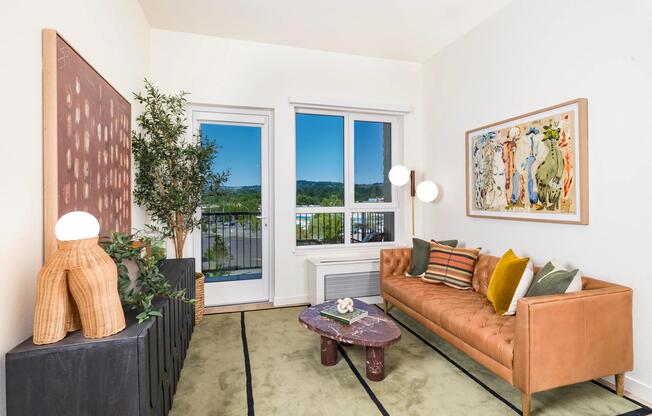 A bright living area at Modera Beaverton with balcony access, curated finishes, and a comfortable layout designed for everyday living and hosting.