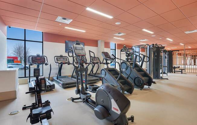 A gym with a variety of exercise equipment.
