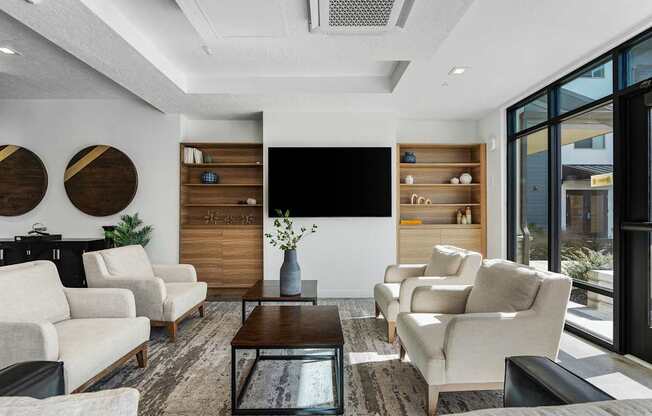 a living room with white furniture and a large window