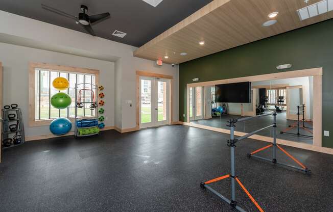 a home gym with a television and exercise equipment at the enclave at woodbridge apartments in sugar at The Bend Arbordale, Williamsburg, Virginia