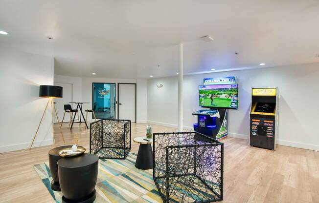 a living room with a tv and a video game on the wall at Presidio Palms Apartments, Tucson, AZ