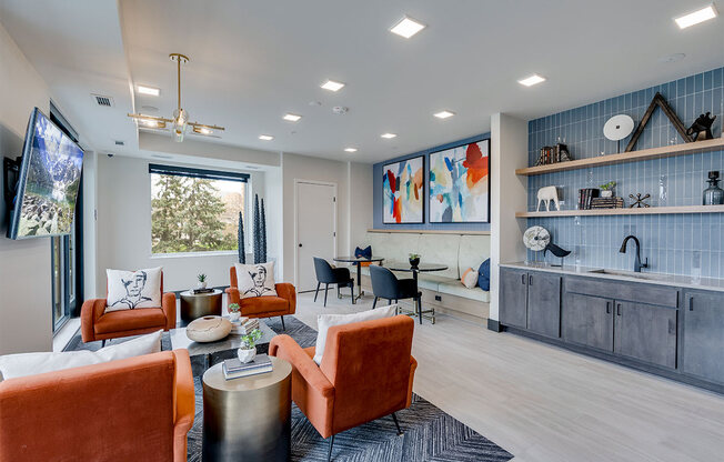 Lounge area with tv and orange chairs