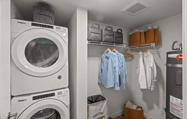A small laundry room with a washer and dryer stacked on top of each other.