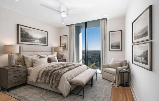 This penthouse bedroom pairs floor-to-ceiling windows with warm textures for a space that feels open and balanced.