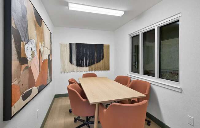 a conference room with a wooden table and chairs at Summerwood Apartments, Santa Clara