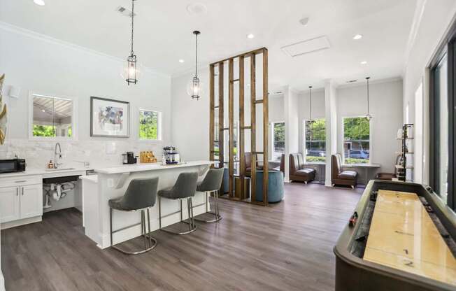 A modern kitchen with a pool table.
