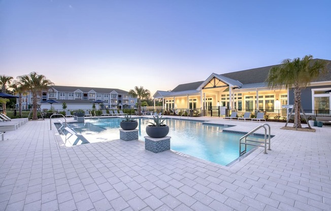 a large swimming pool with a building in the background